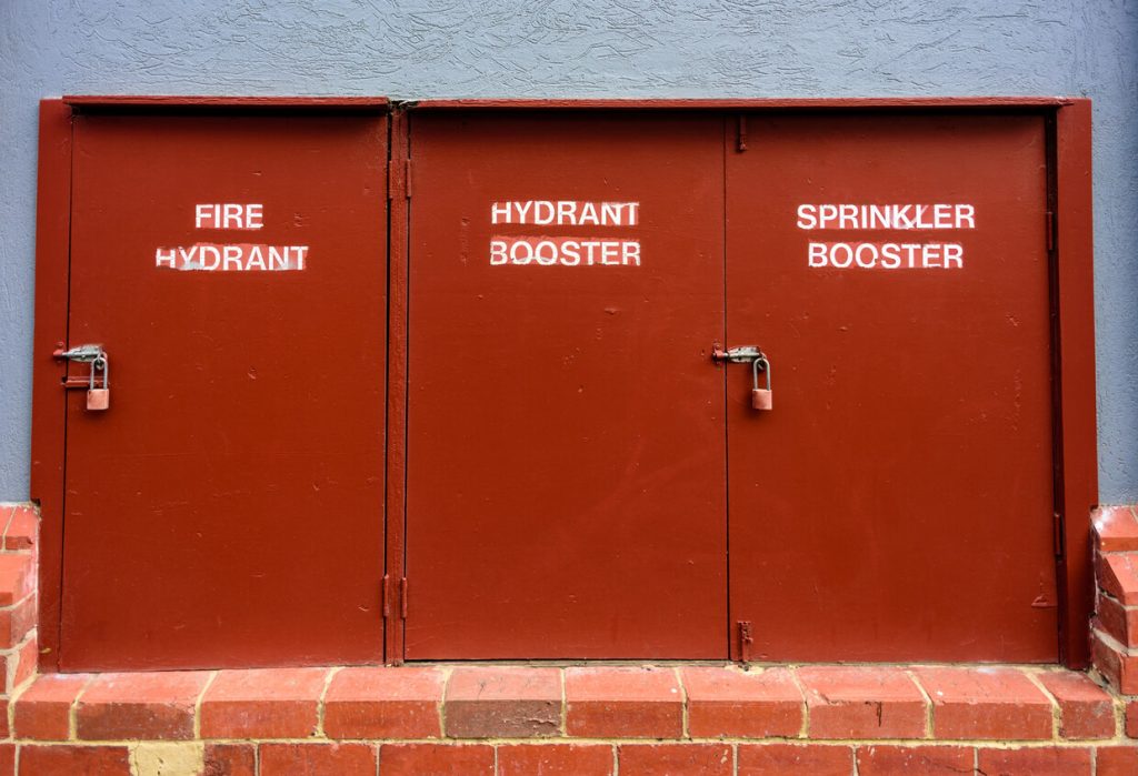 A fire extinguisher outside an apartment building