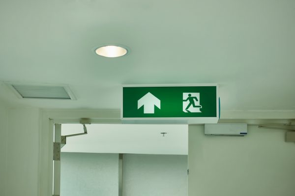 An illuminated exit lighting sign that meets Australian standards