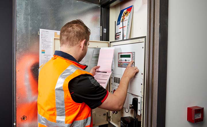 A Fire & Wire service technician providing fire safety maintenance